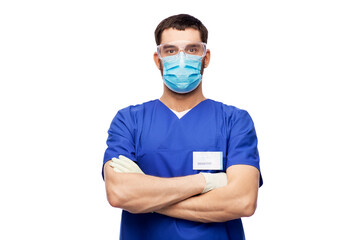 Fototapeta na wymiar healthcare, profession and medicine concept - doctor or male nurse in blue uniform, face protective medical mask for protection from virus disease, goggles and gloves over white background