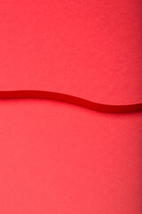 Abstract minimal paper background. Red cut out curvy paper stripe on red background.