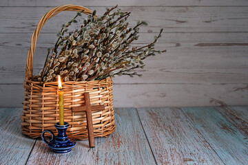 candle, cross and willow branches in wicker bascet. Palm Sunday symbol. Easter, faith, orthodox Church, religion concept © Ju_see