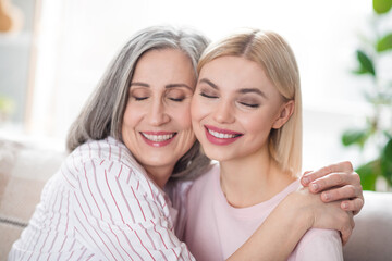 Photo of attractive happy nice family mother and young woman smile hug cheeks smile indoors inside house