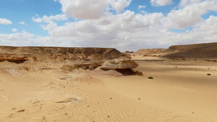 Fototapeta na wymiar The beautiful sands and rocks formations due to erosion in Fayoum desert in Egypt