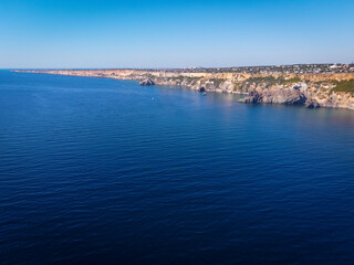 Fototapeta premium Cape Fiolent. Beautiful views of the Black Sea coast at Cape Fiolent in summer in clear weather. Aerial view to beautiful sea coast with turquoise water and rocks