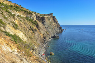 Fototapeta premium Cape Fiolent. Beautiful views of the Black Sea coast at Cape Fiolent in summer in clear weather. Aerial view to beautiful sea coast with turquoise water and rocks