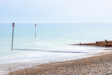 A view of the high tide and tidal poles at the seaside, Worthing