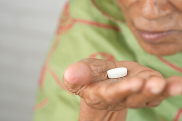 senior hand holding pills with copy space 