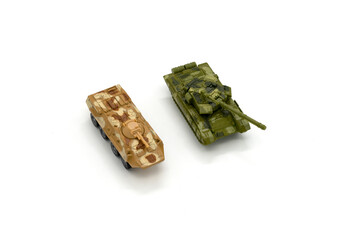 Plastic model of a military toy car and a tank isolated on white background.