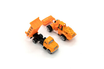Obraz premium Yellow excavator and truck model toys isolated on white background.