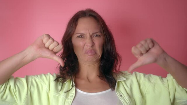 Portrait of Young Woman with Thumbs down
