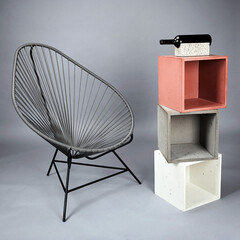 Chair with concrete block shot in studio with flashlight on a grey background