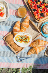 Picnic setting with picnic food, picnic hamper basket, guitar and food ready for party