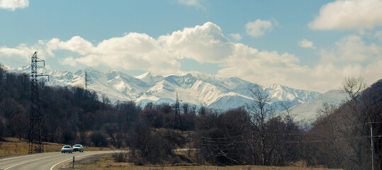 snowy mountains in the distance and the road leading to them