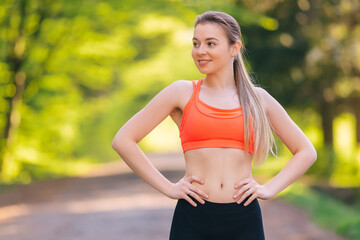 Portrait of fitness young woman outdoors in the park. Sportswoma