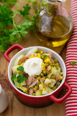Fish salad with tuna, cucumber, green peas and eggs