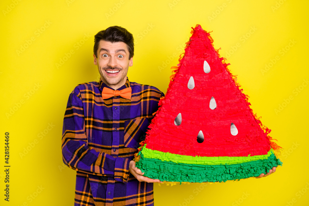 Sticker photo of happy smiling cheerful good mood excited man hold huge watermelon piece isolated on yellow 