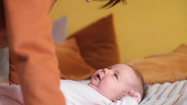 A teenage brother with a cute newborn sister. Sweet and gentle communication. The quality of sibling relationships is one of the most important predictors of mental health in future.