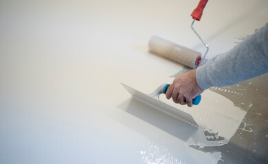 worker works with polyurethane resin for interiors
