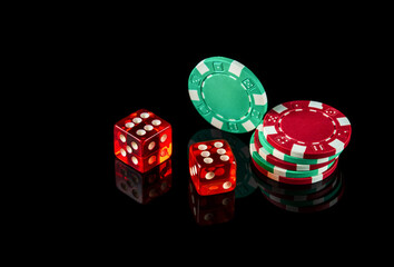 Poker dice on black background and chips. Craps club game concept