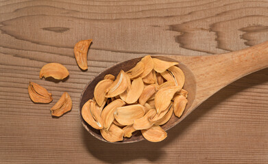 Wooden Spoon Full of Dried Garlic Slices