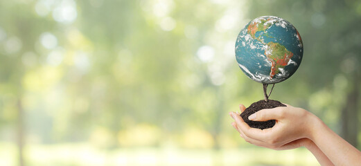 Ecology and Environment Concept : Hand holding blue planet earth with green natural in background. (Elements of this image furnished by NASA.)