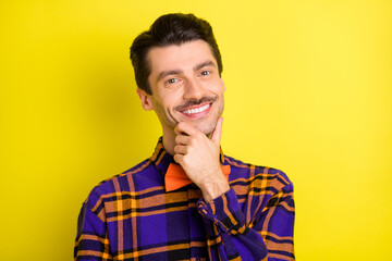 Photo of young handsome man happy positive smile hand touch chin barbershop isolated over yellow color background