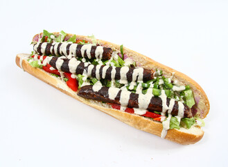 Baguette with spicy sausages with tahini