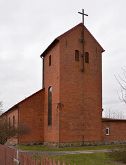 Close-up photos of red brick and windows as well as the belfry of the Catholic Church of Saint...