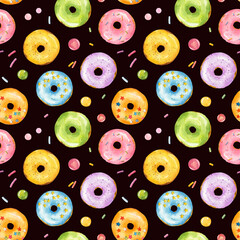 Seamless pattern with watercolor multicolored donuts isolated on black background.