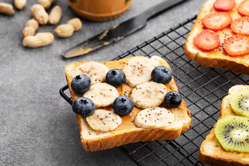 sweet toast with peanut butter, fruit and berries, close-up, banana and blueberry toast