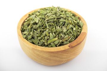 dry chopped spring onion  in wooden bowl on white background. dry chopped or scallion. dry green onion, chopped onion, chopped spring onion.