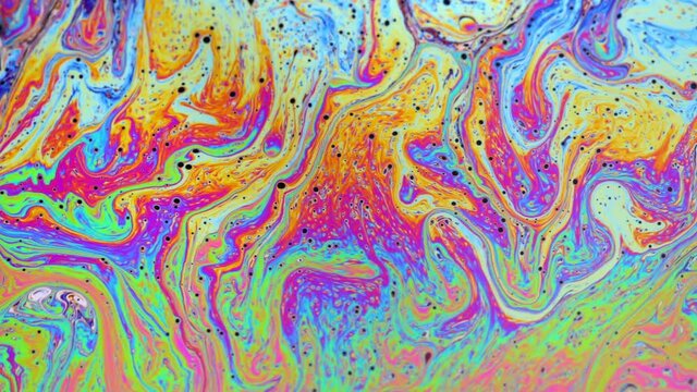 Psychedelic abstract colours and patterns reflecting on a soap bubble.