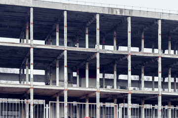 The frame of a multi-storey building on a city building. Construction of a new house, new building