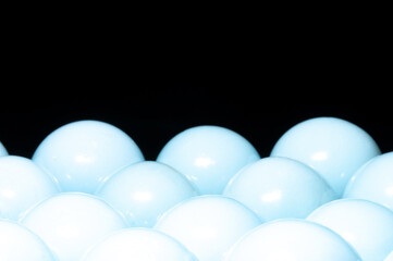 White shiny spheres in black background