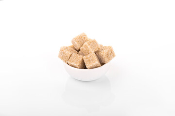 Fototapeta na wymiar brown sugar cubes. brown sugar in white bowl on white background. sugar cubes, cane sugar