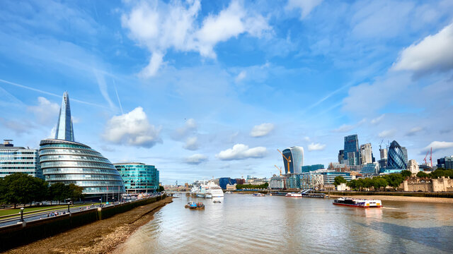 London, South Bank Of The Thames on a bright day in Spring or early Summer. Panoramic image taken from the Tower bridge.