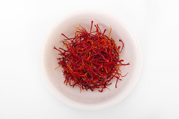 Fototapeta premium saffron. dried saffron in white bowl on white background. saffron spice