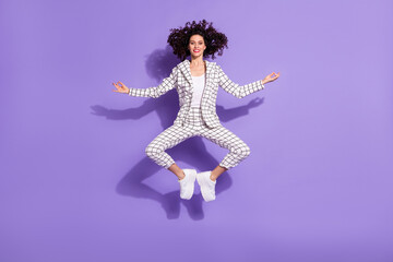 Full length photo portrait of meditating woman jumping up isolated on vivid purple colored background
