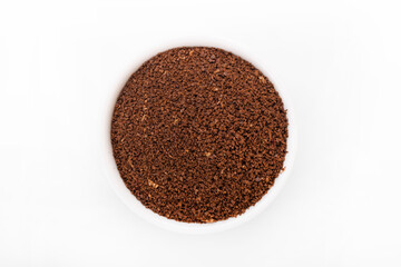 ground coffee. ground coffee in white bowl on white background.