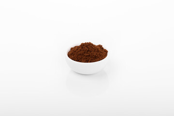 turkish coffee. ground turkish coffee in white bowl on white background.