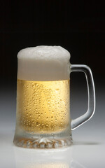 glass of beer on dark background