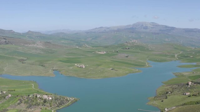 Lake Prizzi in the heart of the Sicani mountains in Sicily. Lush vegetation with wheat crops. Rurality in Sicily. Green in Sicily in spring. Relax by the lake. Migratory birds.