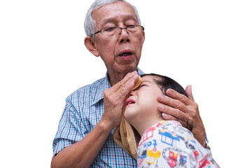 Grandfather wrapped an ice towel and put it on head of the grandson crying from pain. Boy hurts his head. Bulging head child. Adult take care of little boy who is grieving. Isolated white background.