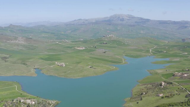 Lake Prizzi in the heart of the Sicani mountains in Sicily. Lush vegetation with wheat crops. Rurality in Sicily. Green in Sicily in spring. Relax by the lake. Migratory birds.