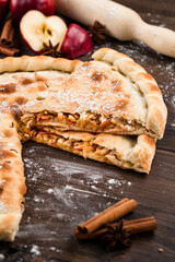 Round closed homemade baked pie with apple