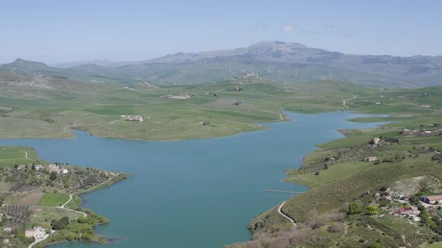 Lake Prizzi in the heart of the Sicani mountains in Sicily. Lush vegetation with wheat crops. Rurality in Sicily. Green in Sicily in spring. Relax by the lake. Migratory birds.
