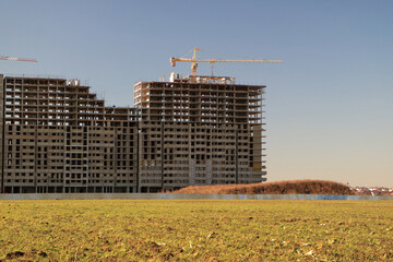 Tower cranes are working on the construction of a new house. Lifting crane.