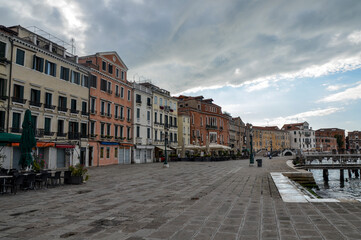 Fototapeta na wymiar Facades of houses on Riva degli Schiavoni. Embankment without tourists near Doge`s Palace and San Marco square, Venice Italy.