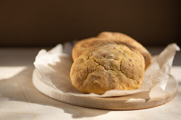 Close-up of yellow homemade cornbread on a wooden background. Selective focus.