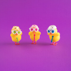 Minimal Easter pattern background with party chicken with hat, tie and glasses. Creative party or holiday concept.