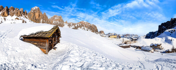 Panorama of Wolkenstein in Gröden in winter with view to the pizes de cir, Grödner Joch and the Sella Group, Dolomite, Italy