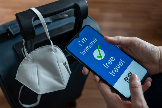 Immunity passport, risk-free certificate concept. A hand in medical gloves holds a passport marked with the outbreak of the coronavirus COVID-19, travel after the pandemic to travel freely repirastor - Powered by Adobe